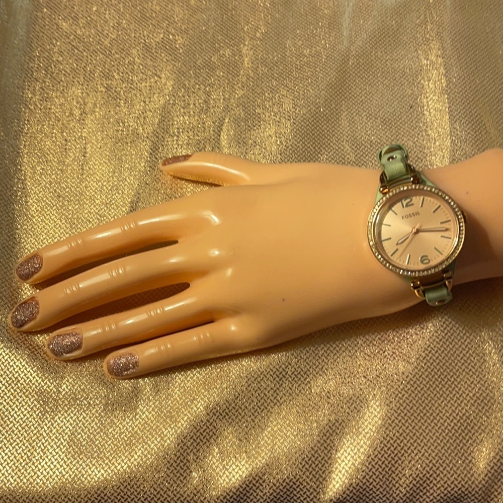 Fossil rose gold with mint green leather band.